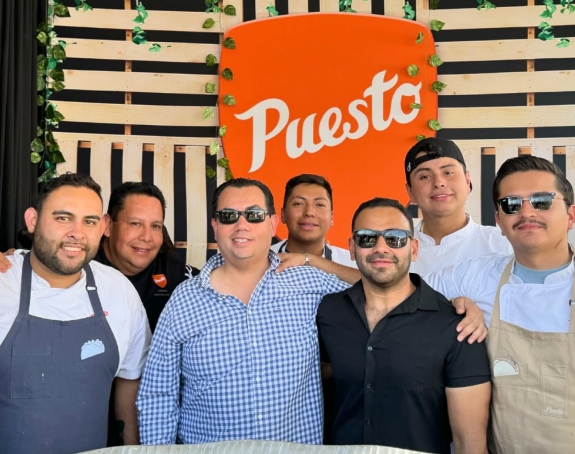 Group of chefs and partners with El Faro Seafood team at Puesto restaurant.