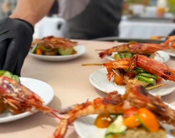 Fresh seafood plates being served at live cooking demo.