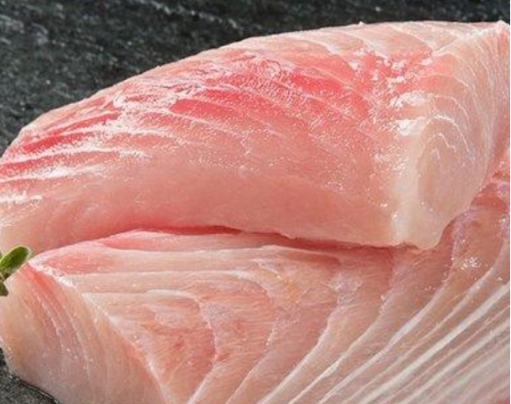 Fresh swordfish steak with visible grain – high protein seafood.