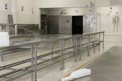 Empty seafood processing facility with stainless steel tables – hygienic and ready for production at El Faro Seafood